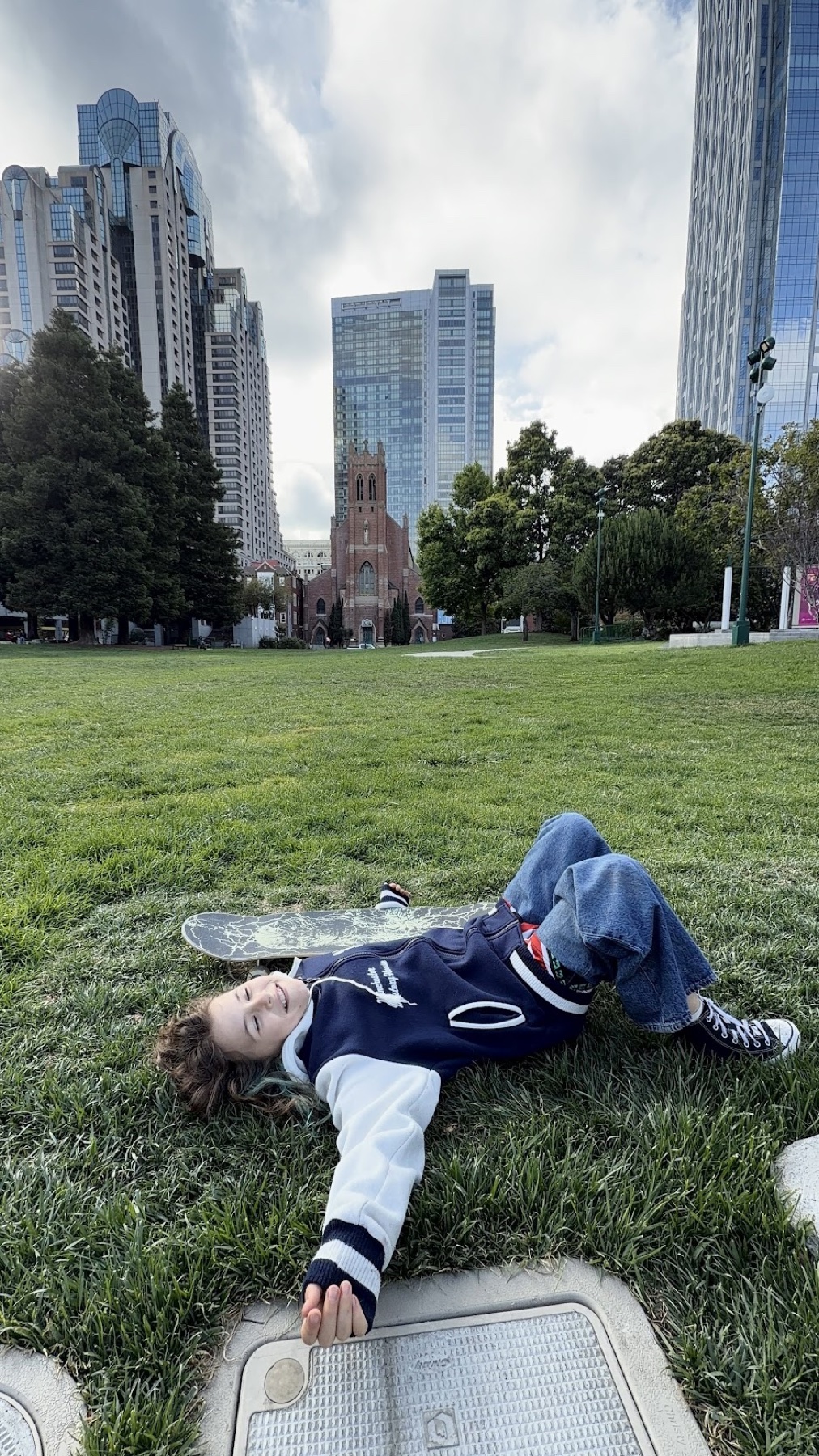 Resting in a San Francisco park with a skateboard